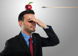 Risk management concept, arrow hitting an apple on a businessman
