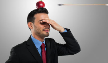 Risk management concept, arrow hitting an apple on a businessman