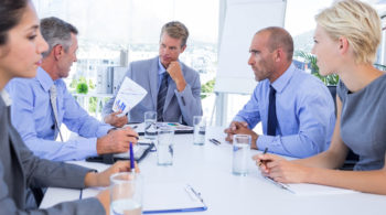 Business people speaking together during meeting in the office